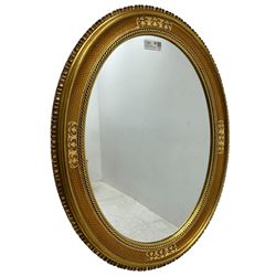 19th century design gilt framed oval wall mirror, shell moulded edge foliate decoration