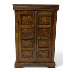 Hardwood cupboard, enclosed by two panelled doors carved with elephants, on plinth base 