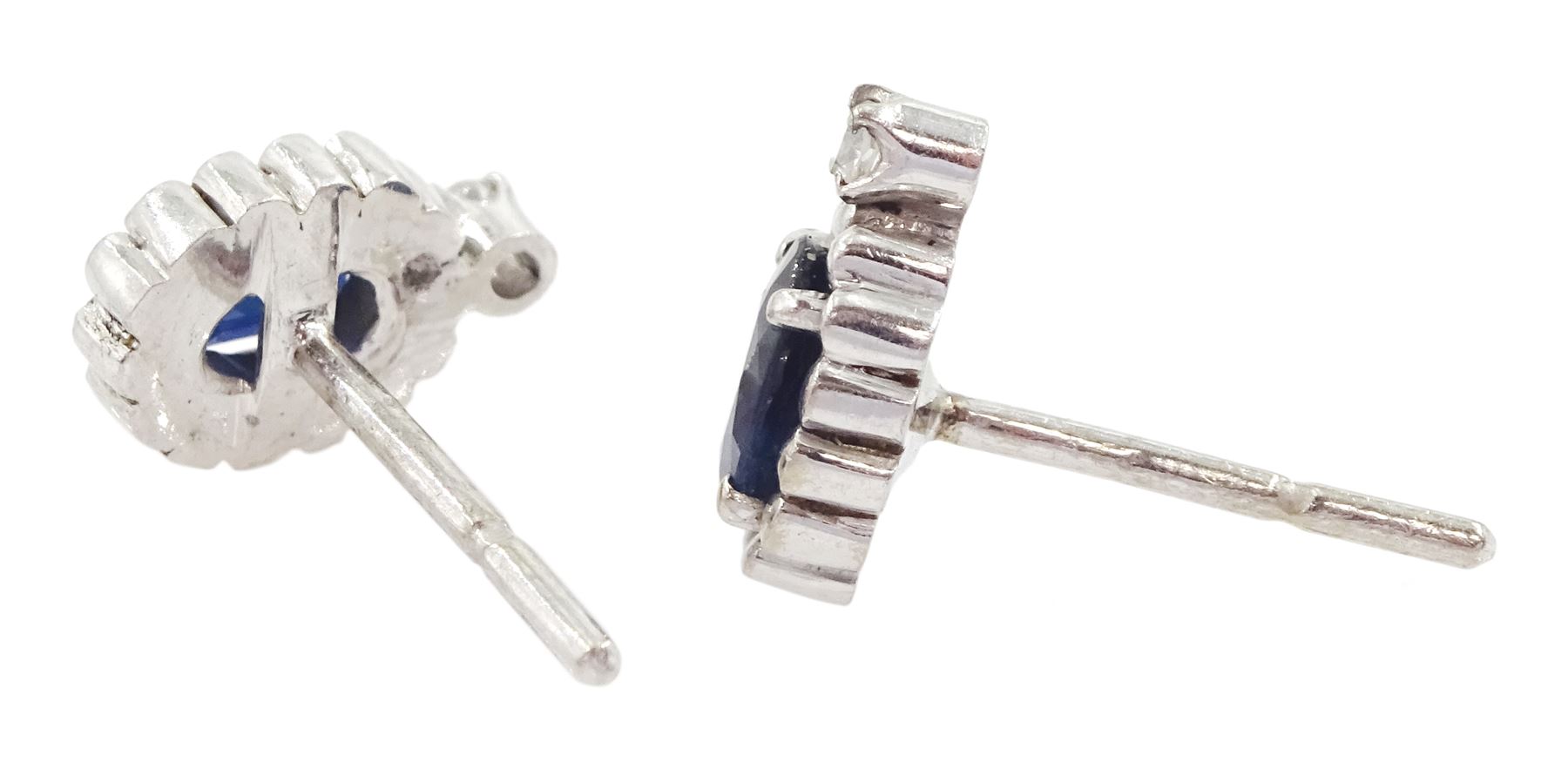 Pair of 14ct white gold oval cut sapphire and round brilliant cut diamond stud earrings