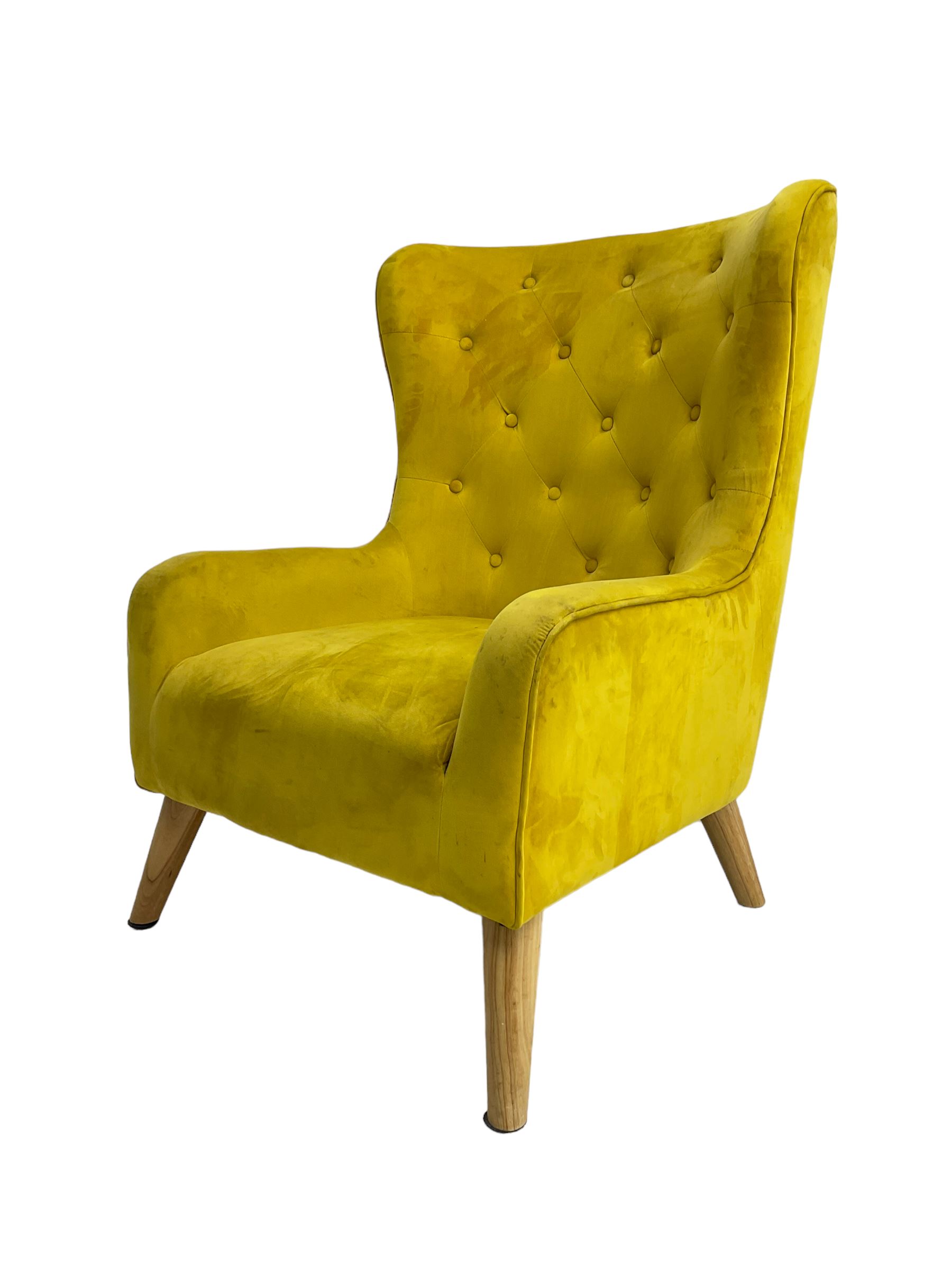 Mid-20th century design armchair, barrel back upholstered in buttoned mustard fabric, on tapering splayed front feet