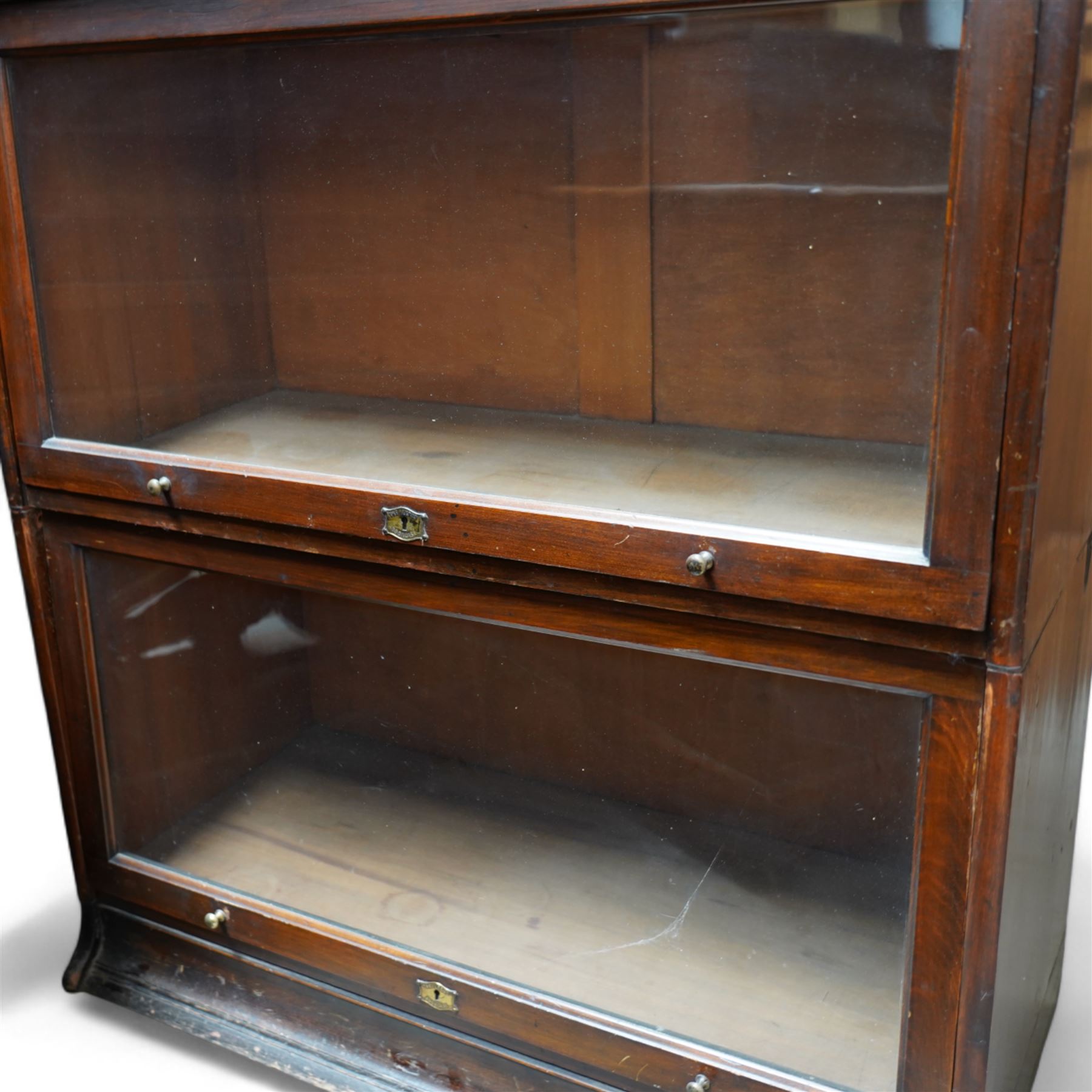 The Lebus Bookcase - early 20th century mahogany Globe Wernicke design three sectional stacking bookcase, fitted with glazed up-and-over doors 