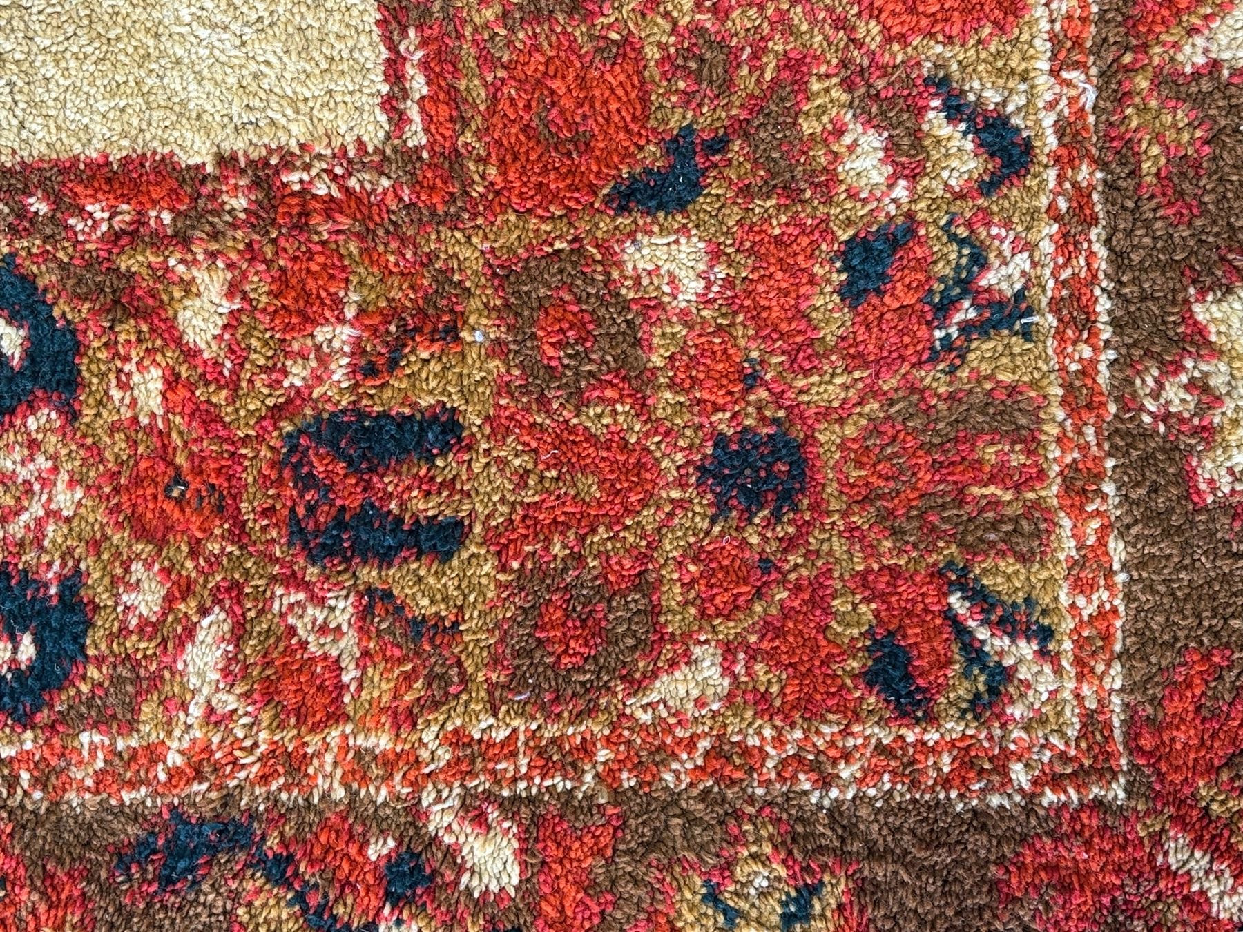 Moroccan amber ground thick pile rug, the plain ivory field decorated with a central pole medallion of star form, the wide guard bands decorated with repeating geometric and foliate patterns