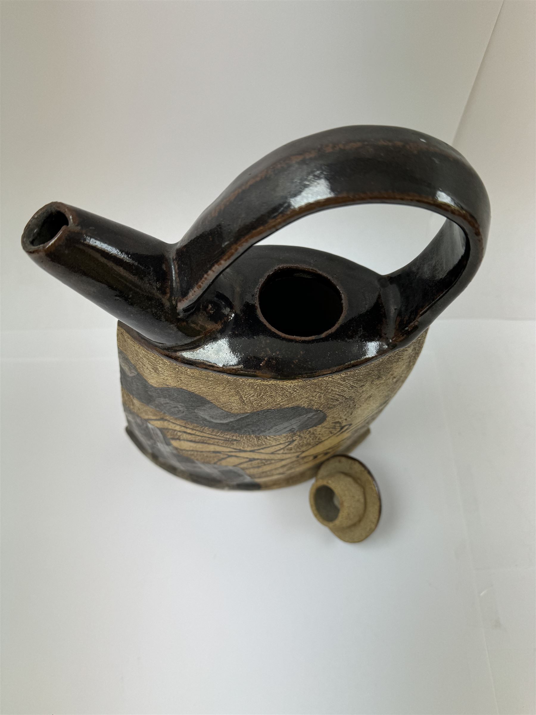 John Maltby (British 1936-2020): studio pottery teapot decorated with flowers, the spout and handle with tenmoku glaze, signed beneath, including handle H29cm