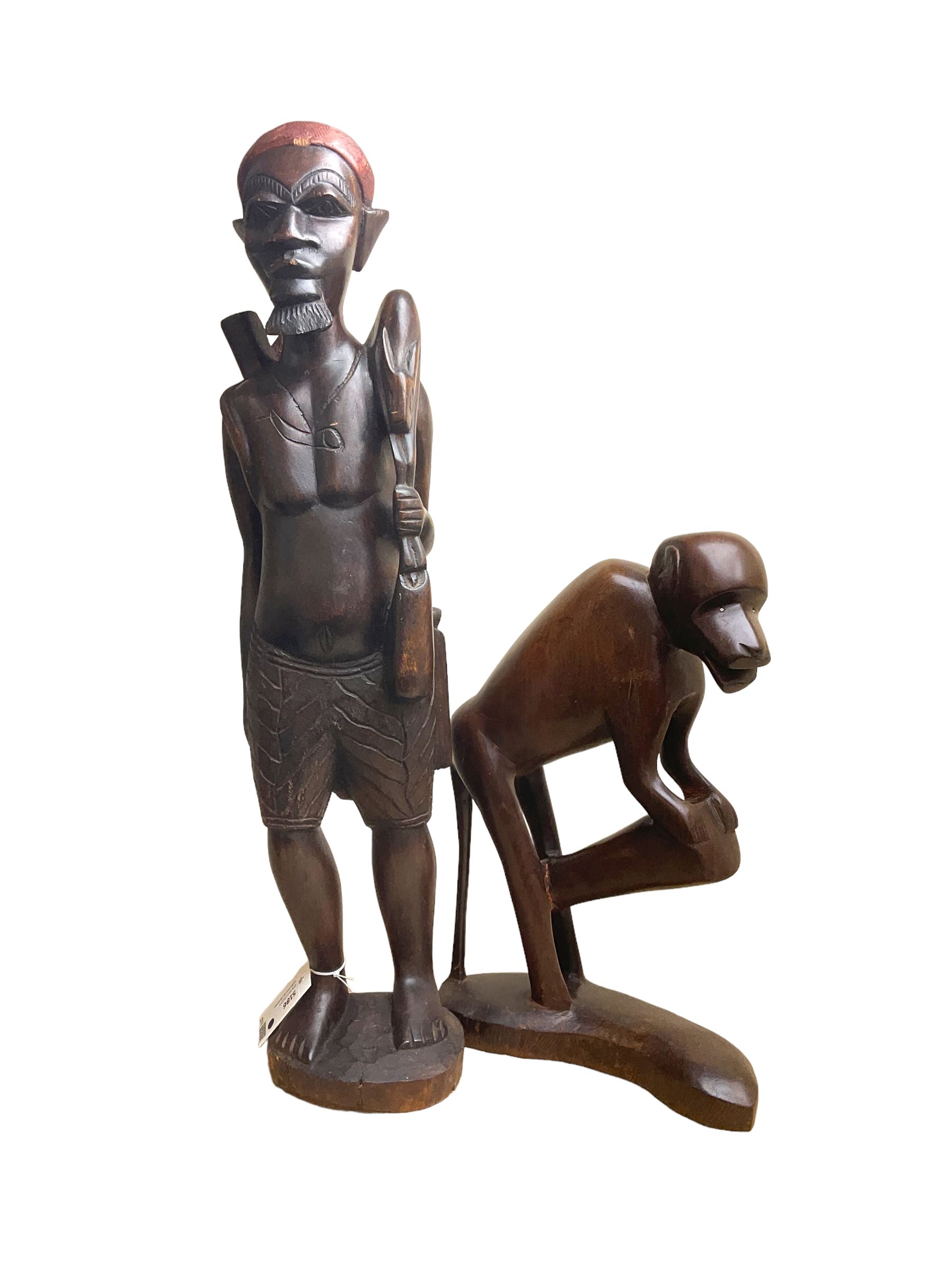 Two African carved hardwood figures, the first carved as a monkey, H43cm, the second as a male figure, H70cm