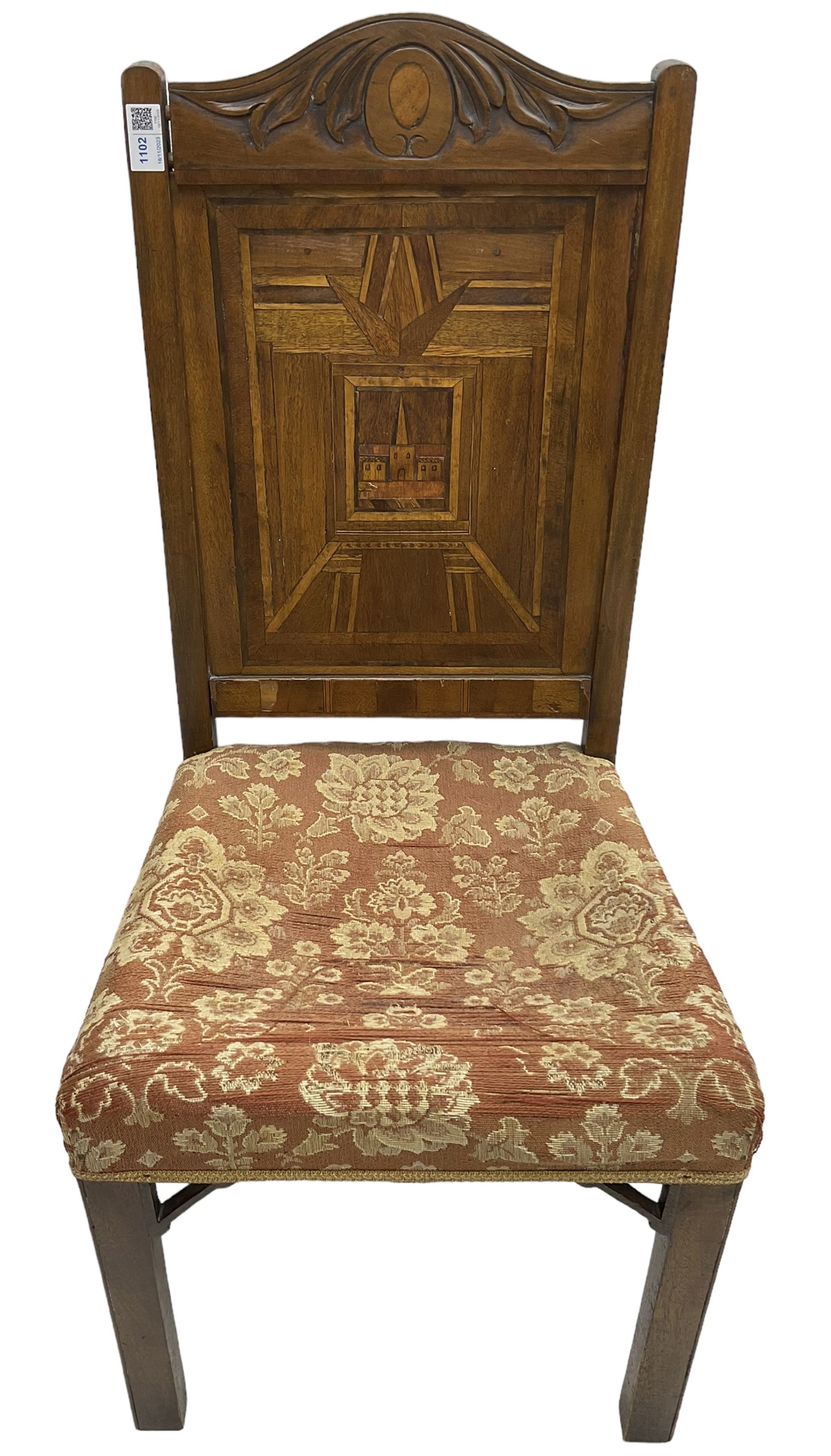 19th century walnut side chair, foliage carved cresting rail over geometric inlaid back with central panel depicting buildings, upholstered seat, on moulded and chamfered square supports