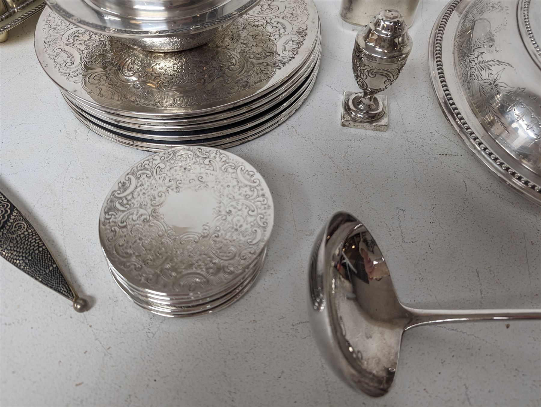 Glass hip flask, with silver cap/collar and plated cup and a silver topped pepper shaker, together with silver plated items including place mats, coasters, serving dishes, etc