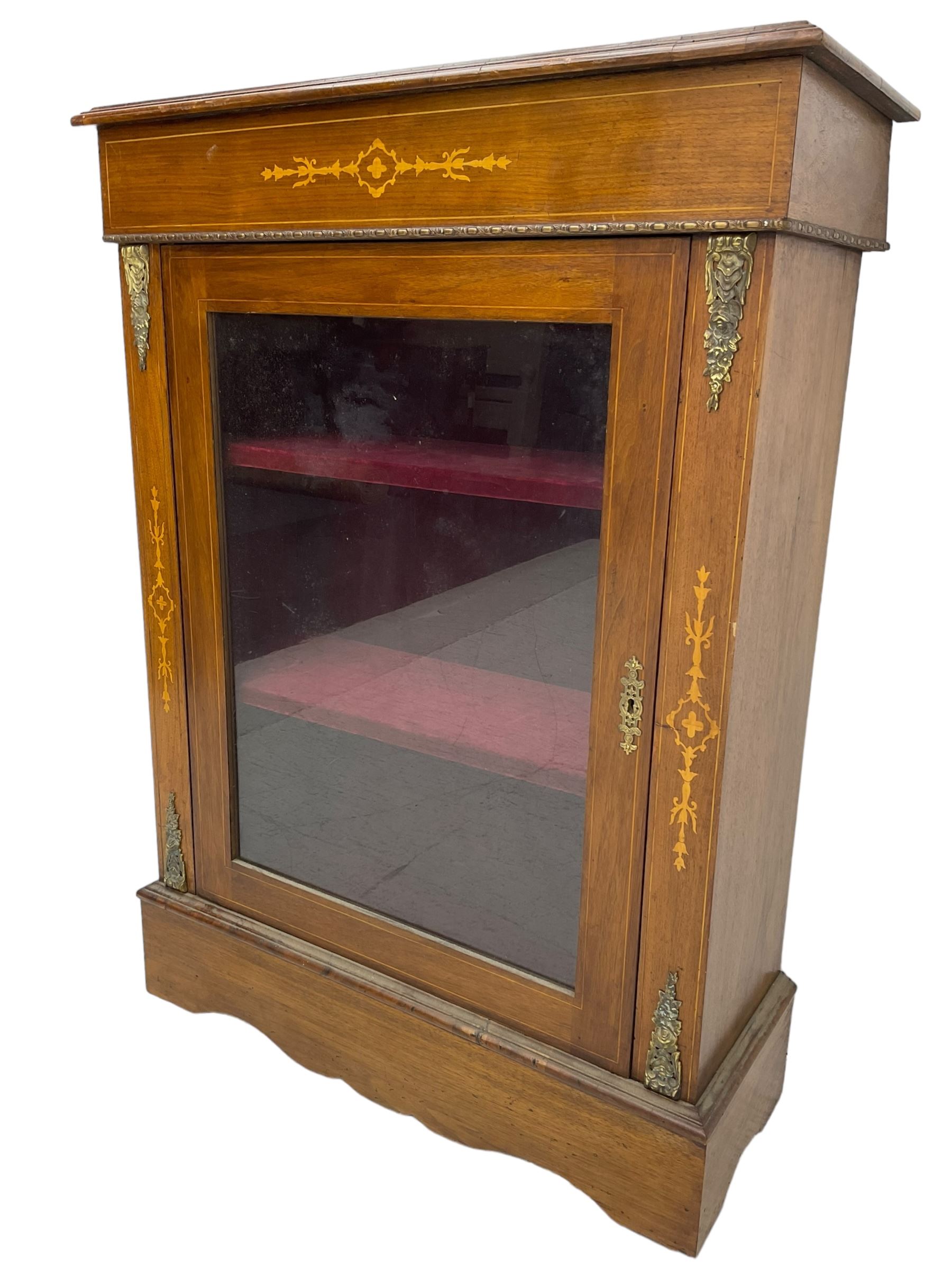 Victorian walnut pier cabinet, moulded rectangular top over inlaid frieze, enclosed by single glazed door, the uprights inlaid with extending stylised foliage decoration and cast gilt metal mounts, on moulded plinth base