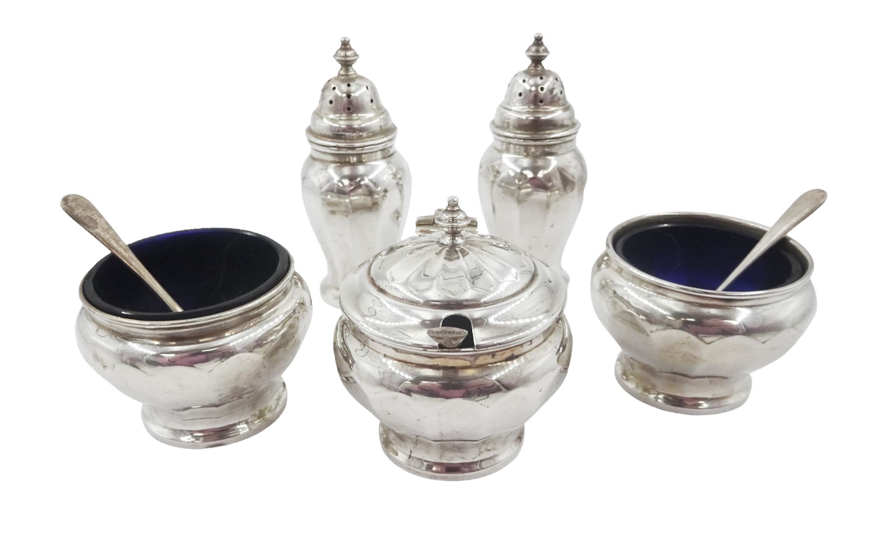 1930s five piece silver cruet set, comprising pepper shakers, open salts and mustard pot and cover, with three silver condiment spoons, hallmarked Adie Brothers Ltd, Birmingham 1932, the salts and mustard each with blue glass liners 