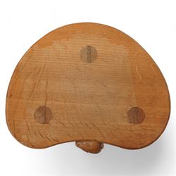 Rabbitman -  oak milking stool, dished kidney shaped top, three tapered octagonal supports, carved with rabbit signature, by Peter Heap, Wetwang