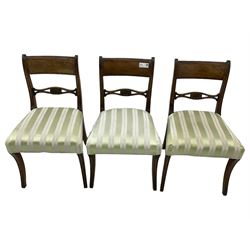 Set of six early 19th century mahogany dining chairs, bar cresting rail over pierced and shell carved middle rail, reed moulded uprights, upholstered seats on reed moulded sabre supports 