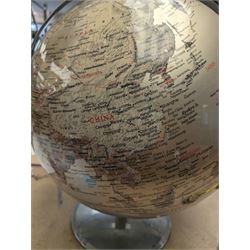 World globe, with red and black writing on a silvered ground, H50cm