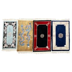 Collection of four Chinese washed woollen rugs - blue ground (153cm x 92cm); red and black ground (156cm x 94cm); light blue ground (138cm x 70cm); gold ground (153cm x 77cm)