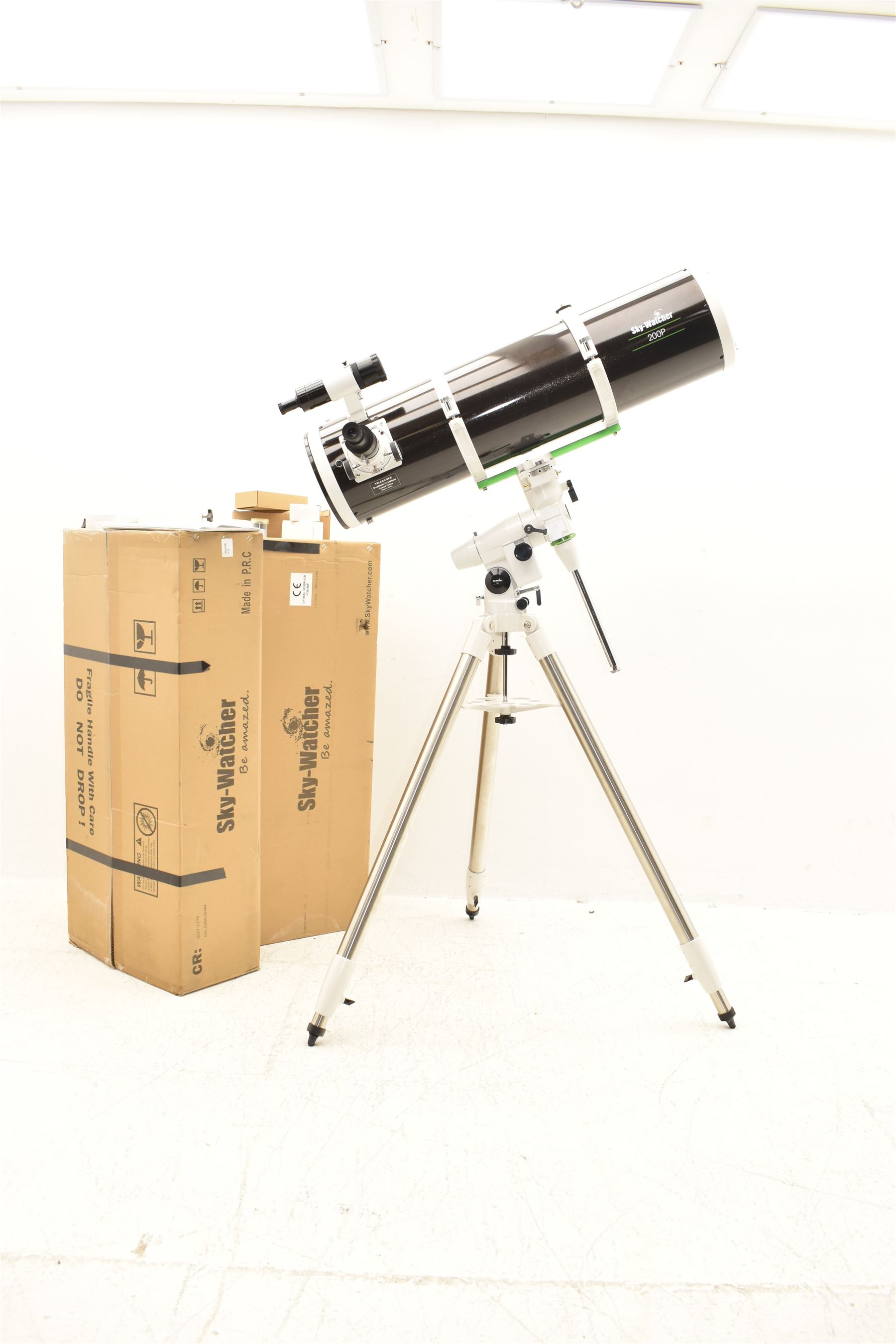 Sky Watcher 200P Newtonian 10” reflector telescope, NEQ3 tripod with counter weights, equatorial mount and finder scope, with a basic 1.25” smartphone adapter and accessories including a Super 10 long eye relief , Celestron 10mm lens, 2 x 1. Barlow lens and super 25 wide angle long eye relief lens. With assembly instruction manual and astronomical telescope user guide.