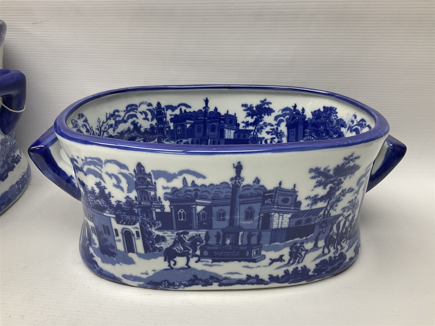 Three Victoria Ware blue and white footbaths, each with twin lug handles and transfer print decorated with city scape, largest H21cm