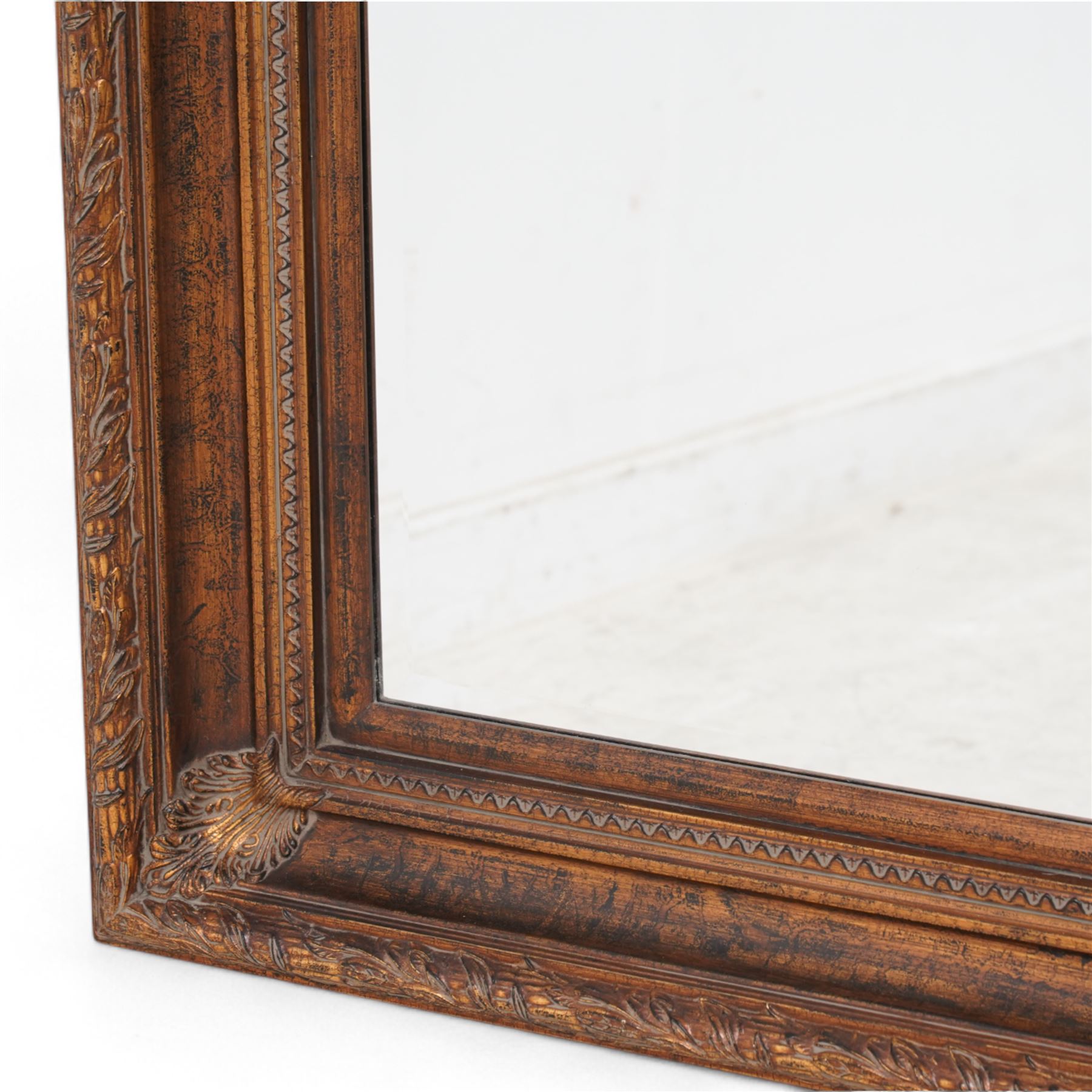 Gilt framed wall mirror, the moulded rectangular frame decorated with trailing laurel leaves and acanthus leaves, bevelled mirror plate 