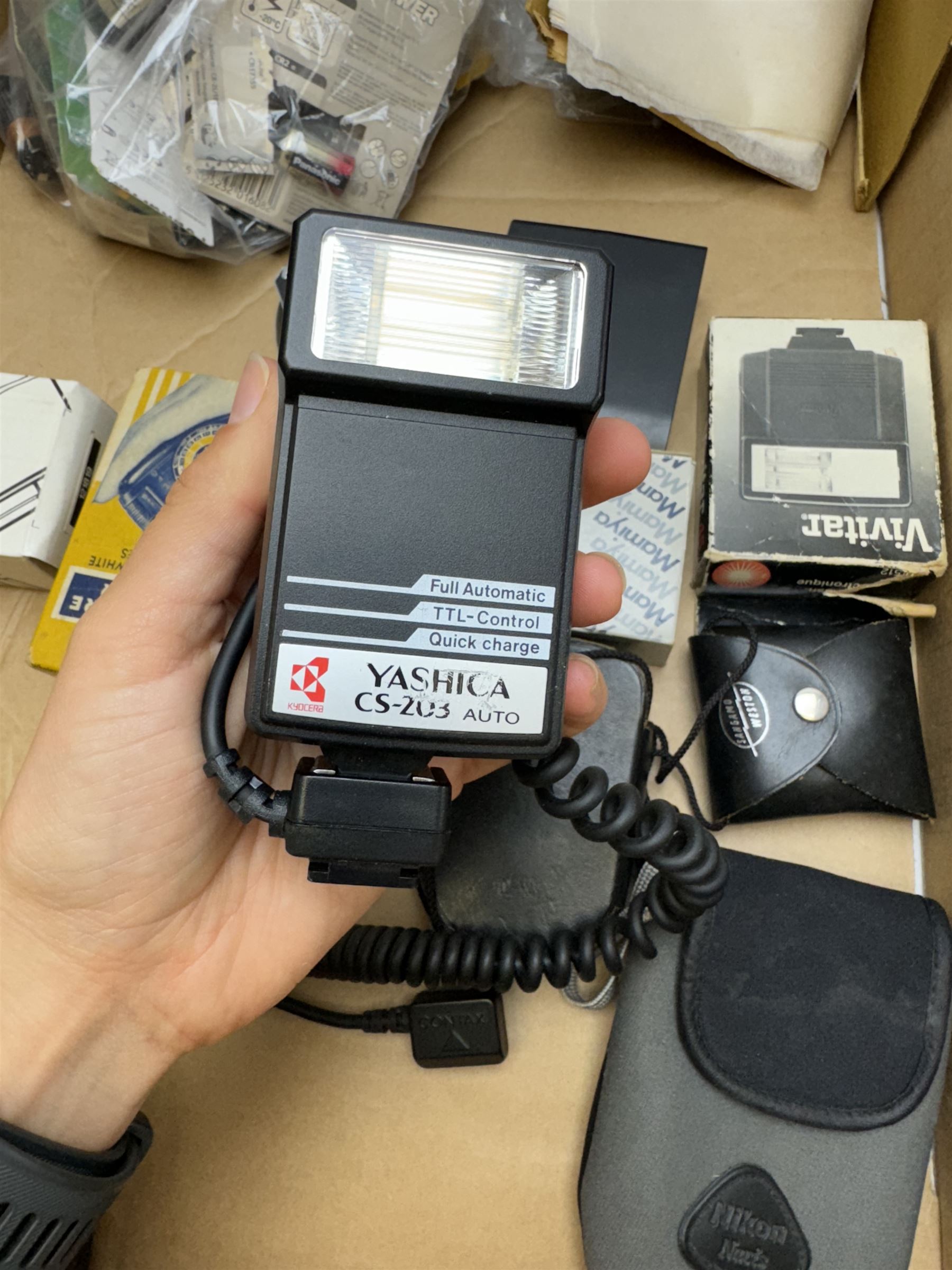 Collection of camera accessories, including Cobra 700AF flash, Weston Euro-Master exposure meter, cases, grips batteries, etc 