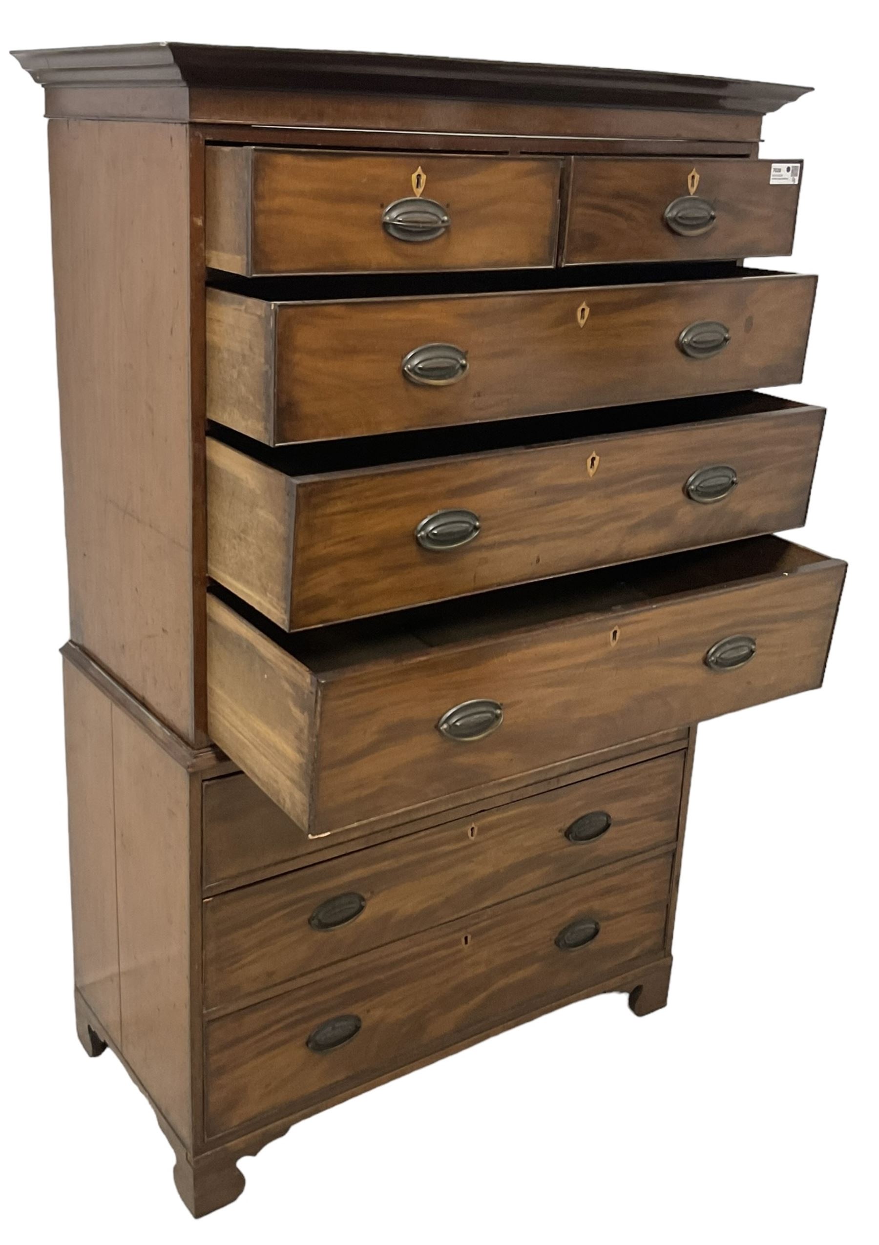 Early 19th century mahogany chest-on-chest, projecting cornice over banded frieze, fitted with two short over six long graduating cock-beaded drawers with bone and timber escutcheons, on bracket feet