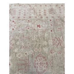 Persian design pale ivory ground carpet, decorated with stylised plant and leaf motifs in pale red