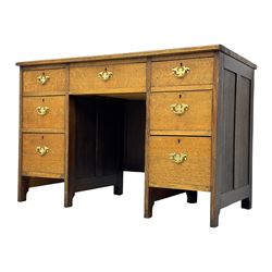 Edwardian oak twin pedestal desk, moulded rectangular top with inset writing surface, fitted with seven drawers, panelled sides, on stile supports 