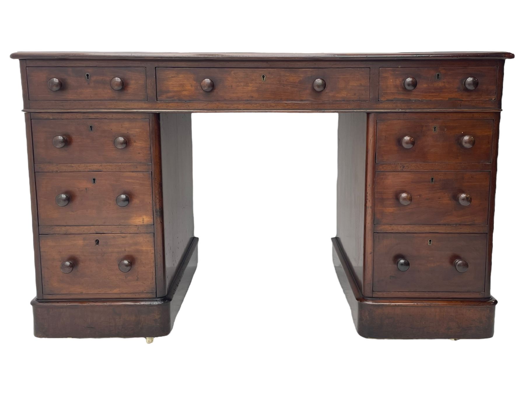 Victorian mahogany twin pedestal desk, moulded rectangular top with inset leather writing surface, nine drawers each fitted with two turned handles, on moulded plinth base 