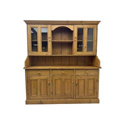 Large pine dresser, raised display cabinets over three drawers and three panelled cupboards, on plinth base