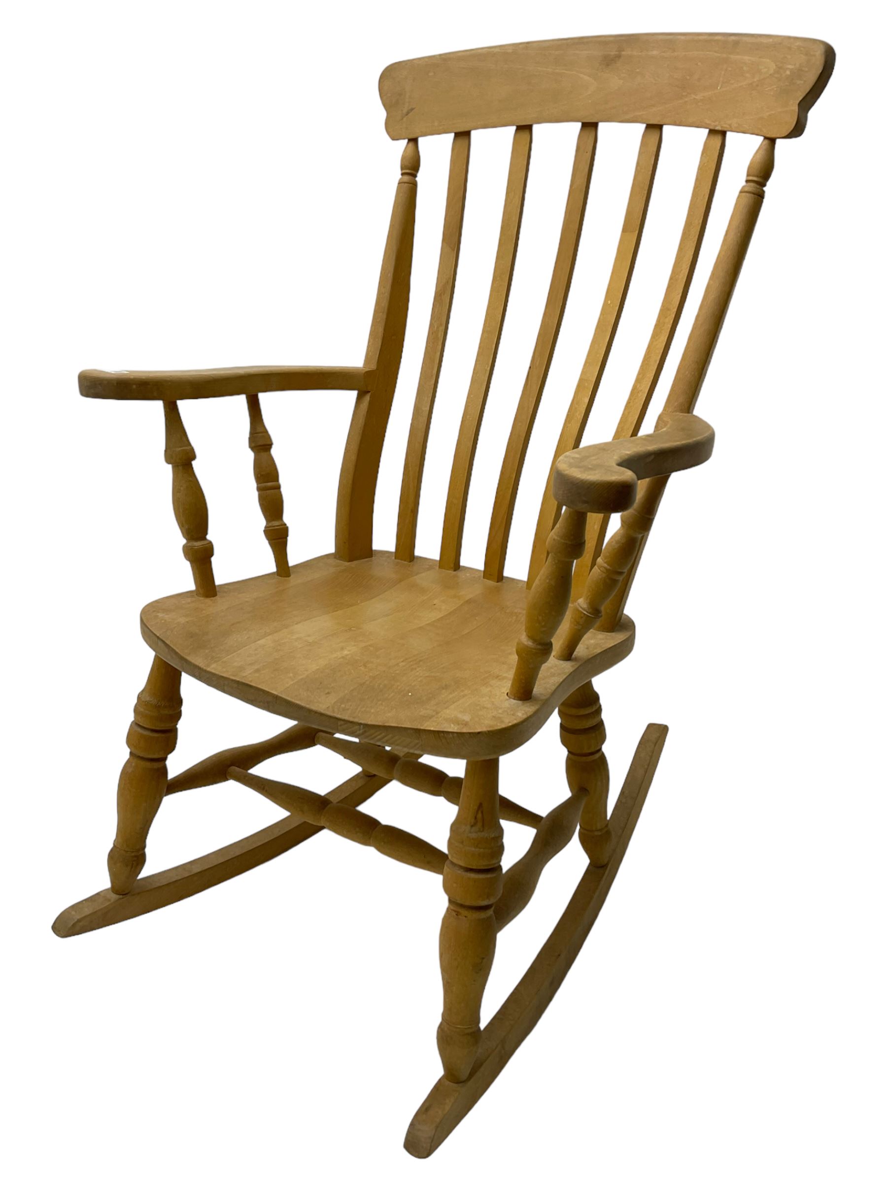 Farmhouse style beech rocking chair, shaped cresting rail on vertical slats, on turned front supports joined by swell-turned double H stretcher base