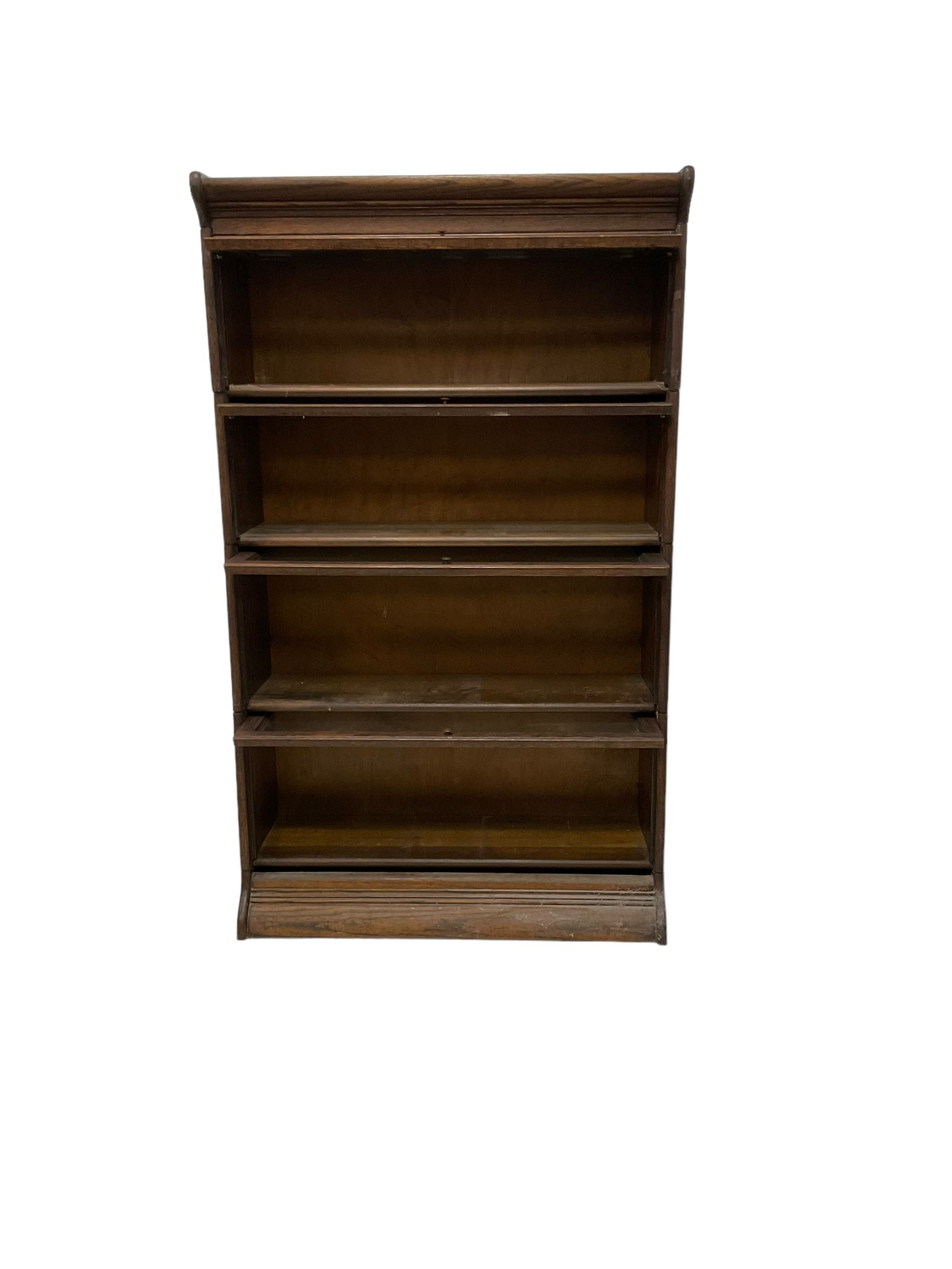 Early 20th century oak Globe Wernicke design sectional library bookcase, four sections each with hinged sliding glazed door, on moulded base 