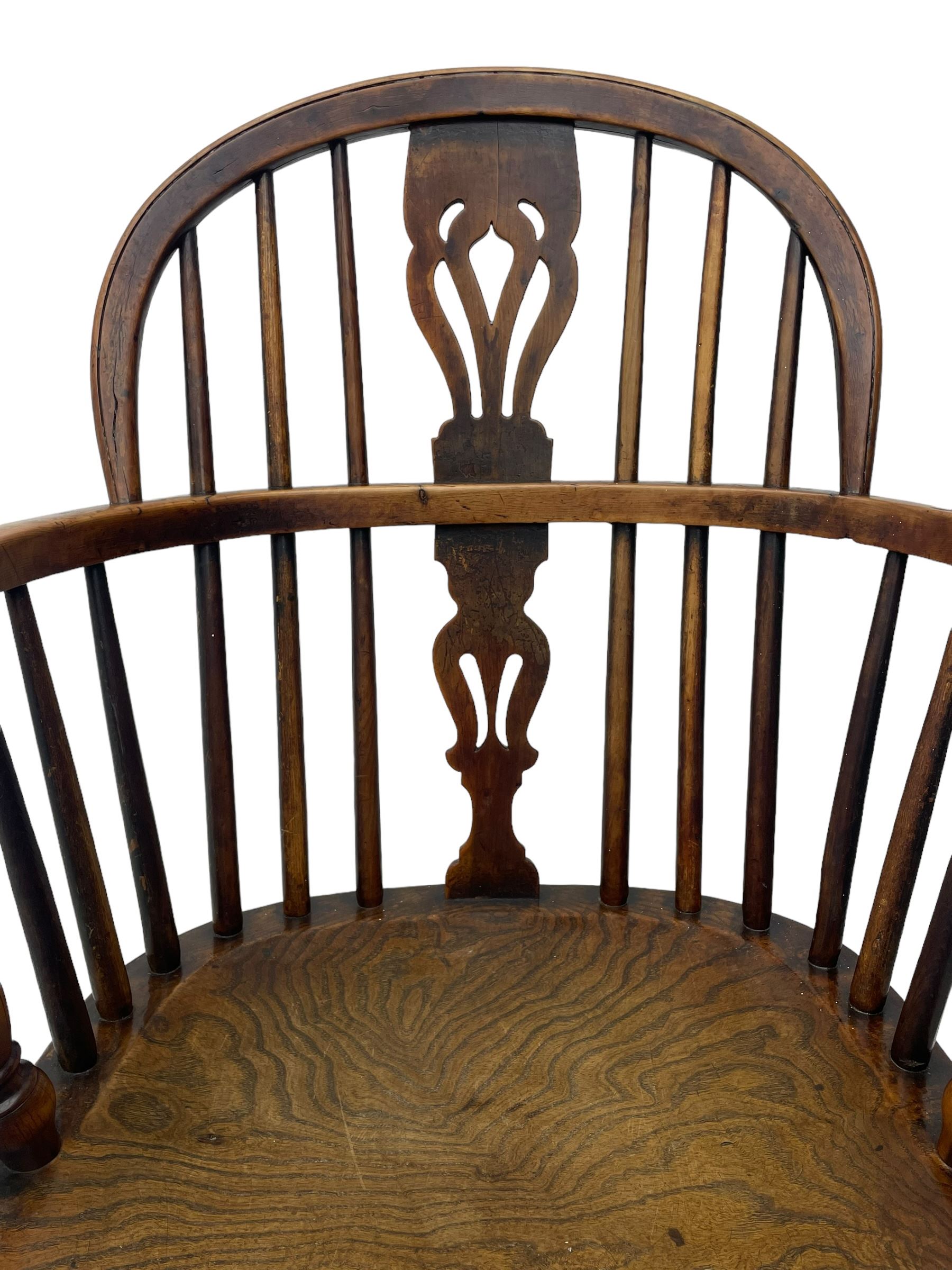 19th century yew wood and elm Windsor armchair, low double hoop stick and pierced splat back, dished seat on turned supports united by crinoline stretchers