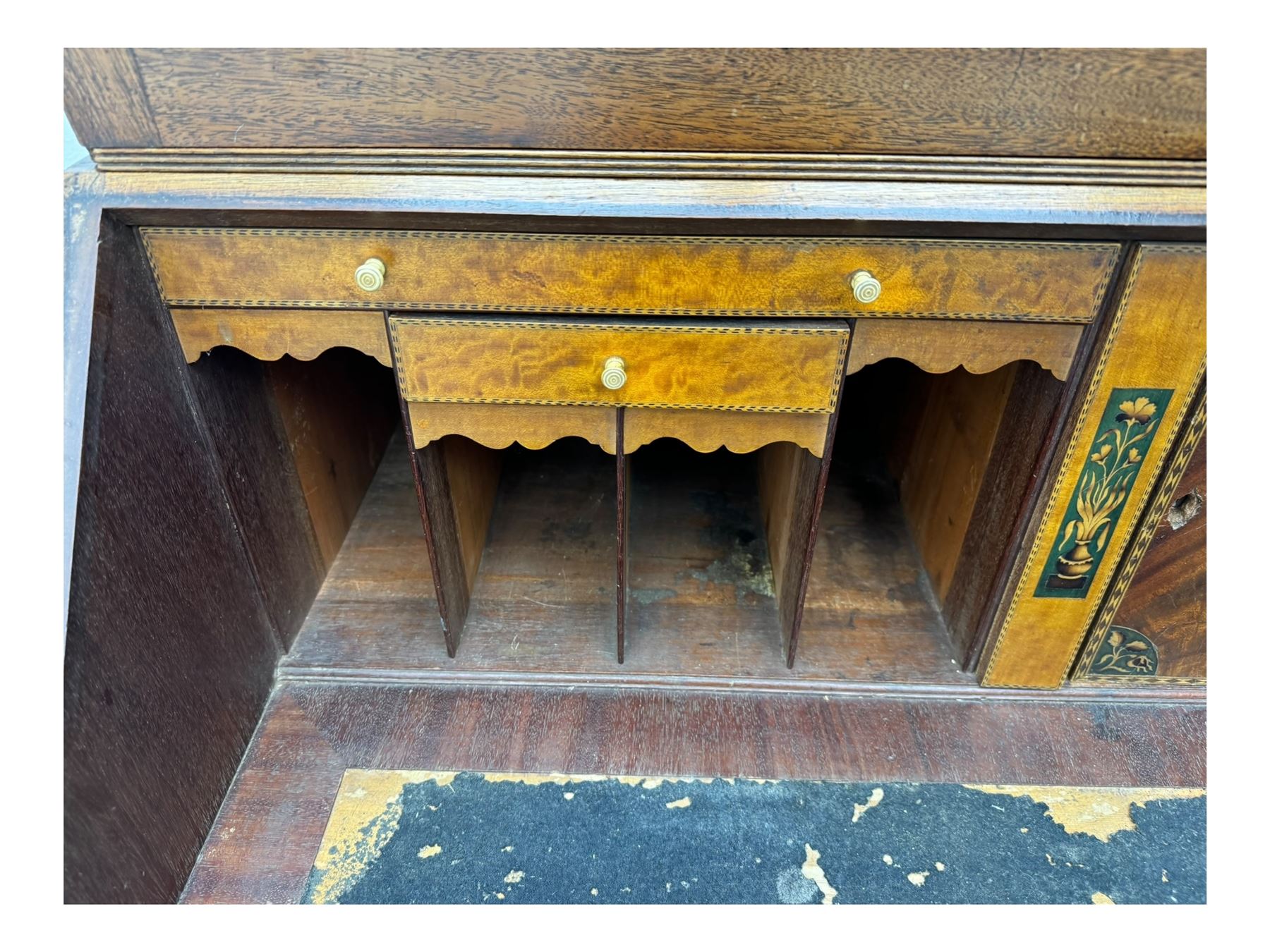 Early 19th century mahogany bureau bookcase, the projecting cornice over two Gothic-style astragal glazed doors enclosing two adjustable shelves, sloped hinged lid enclosing fitted interior and felt inset, four graduating drawers, on bracket feet