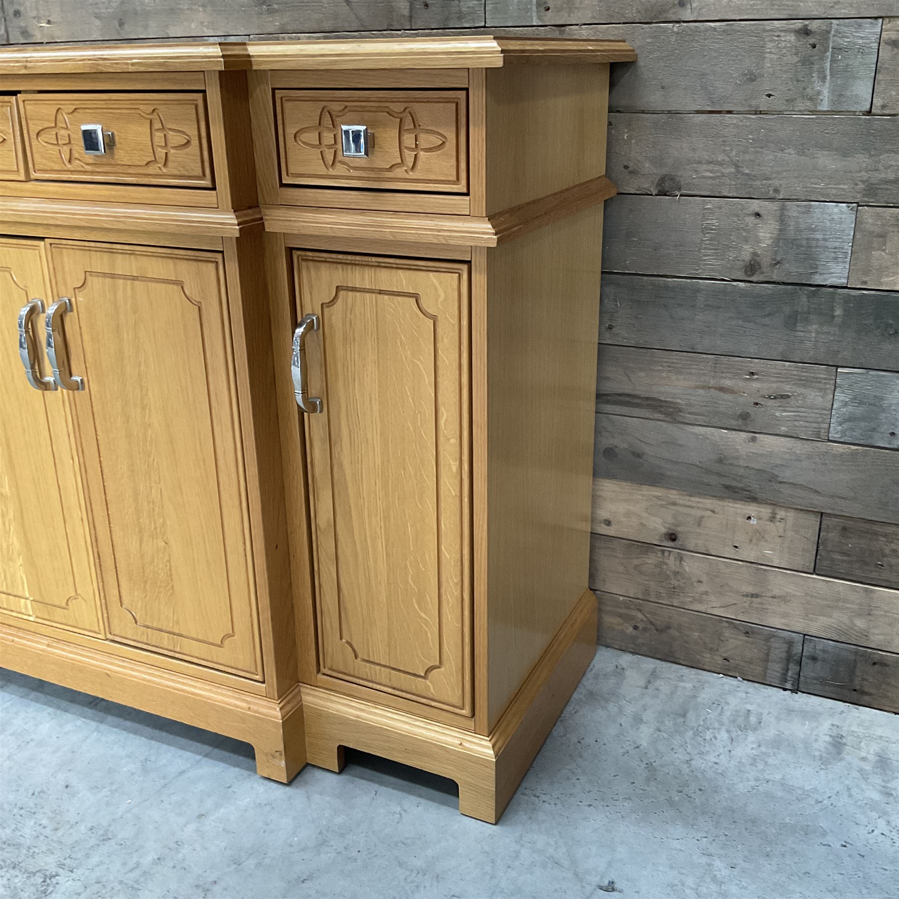 Light oak breakfront sideboard dresser, fitted with four drawers and four cupboards