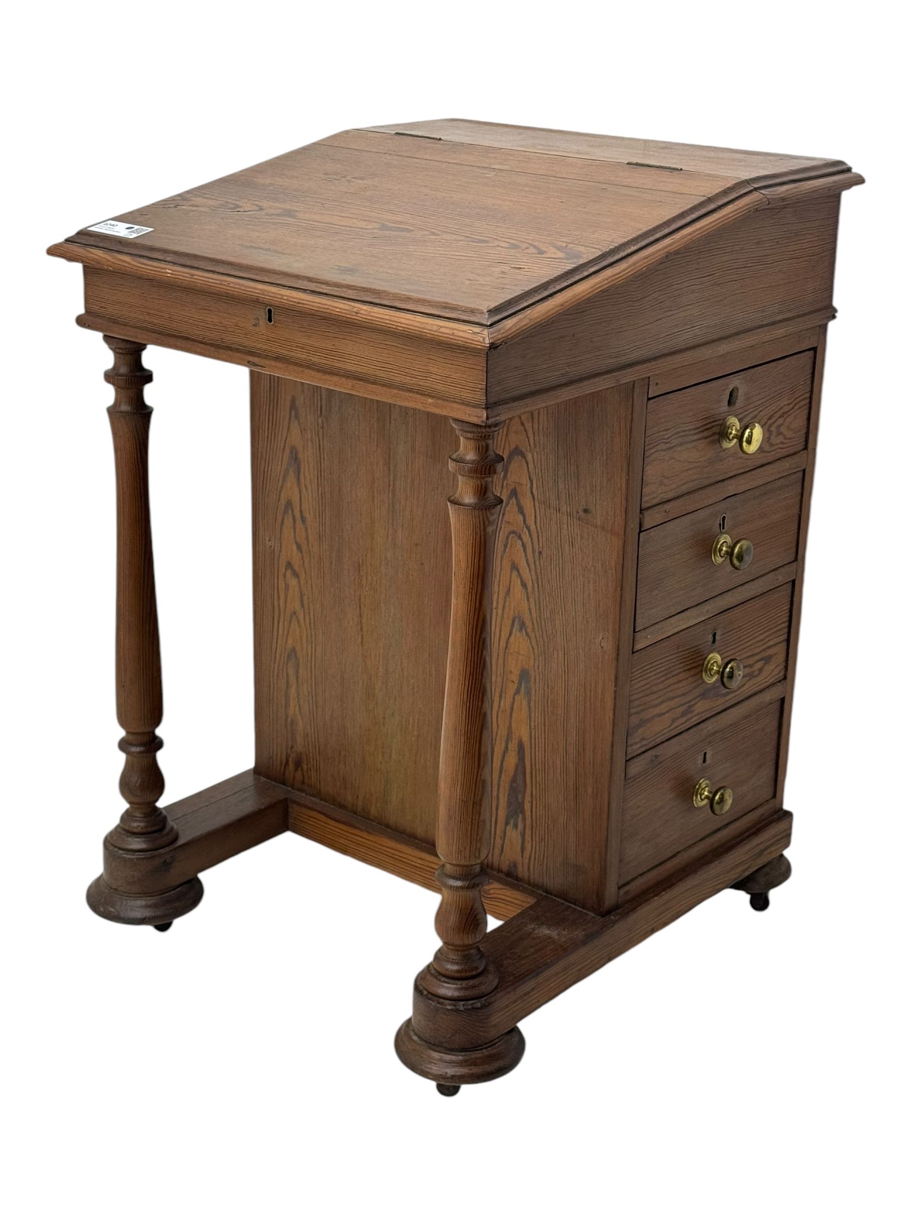 19th century pitch pine Davenport desk, sloping hinged top, fitted with four drawers, on turned column supports, turned compressed feet with castors 