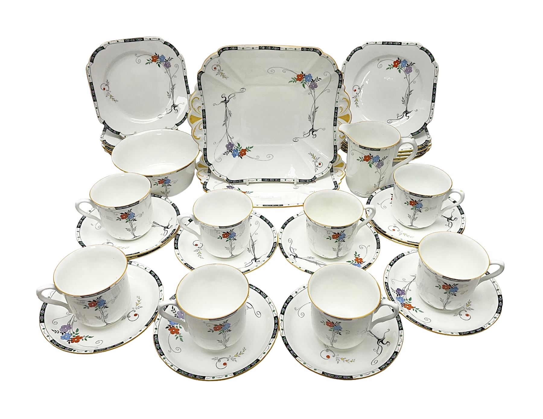 Art deco Shelley tea service for eight, decorated with floral sprigs, comprising teacup and saucers, dessert plates, two cake plates, milk jug and open sucrier, with to extra dessert plates