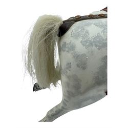 Mid 20th century rocking horse, dappled grey painted horse with applied mane and tail, red leather saddle and bridle accented with brass studs, supported by a stained wooden frame with turned supports and iron brackets, mounted on rockers