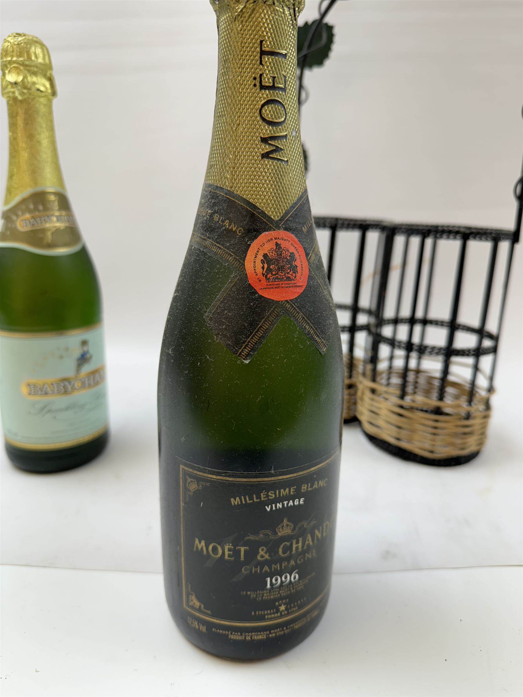 Moet & Chandon 1996 champagne, together with Babycham sparkling perry, in a wine holder, various contents and proof 