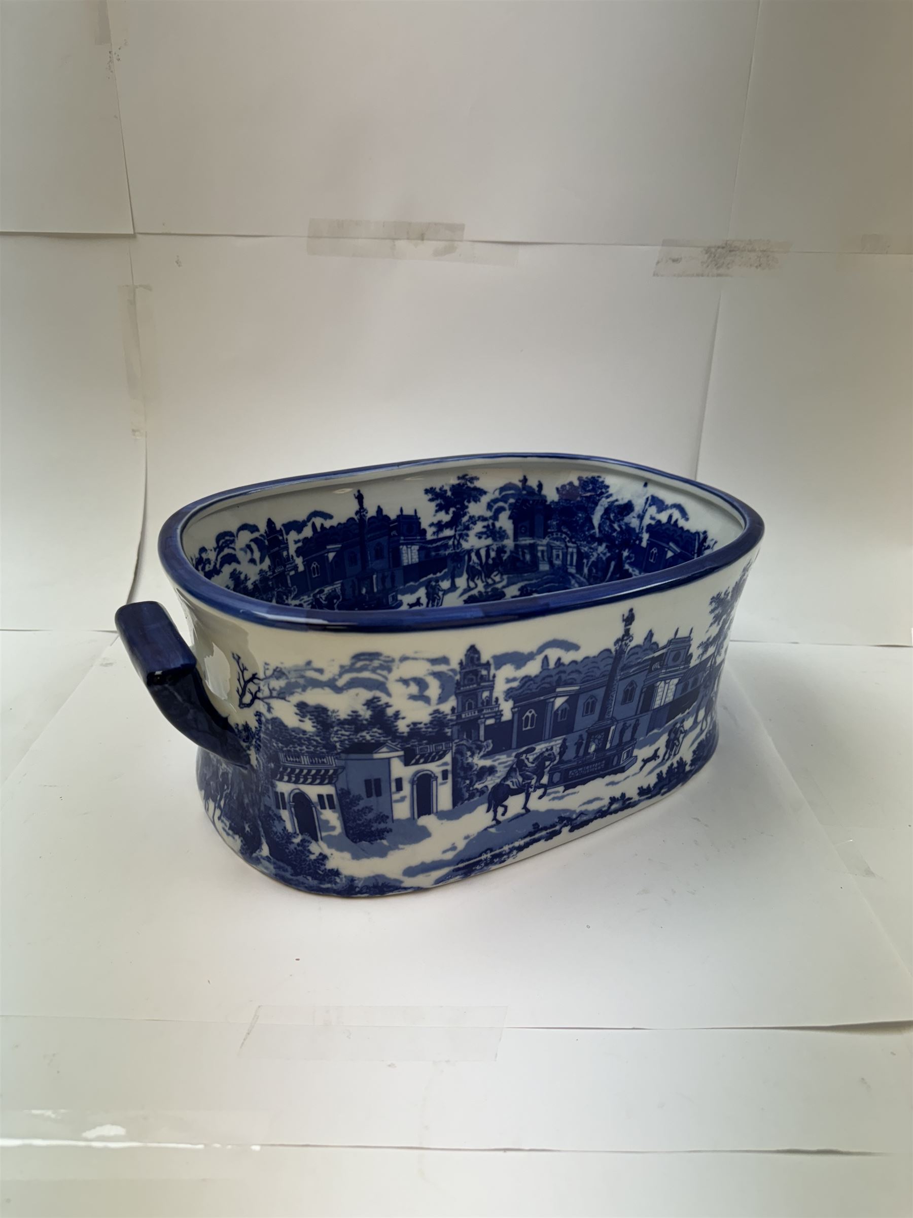 Pair of Victorian style blue and white footbaths, each with twin lug handles and transfer print decorated with city scape, H14cm