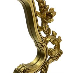 Rococo design gilt framed wall mirror, shaped moulded frame decorated with flower heads and scrolling foliage, plain mirror plate 