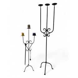 Pair of wrought iron candlesticks, each with a triple branch design, the tallest measuring...