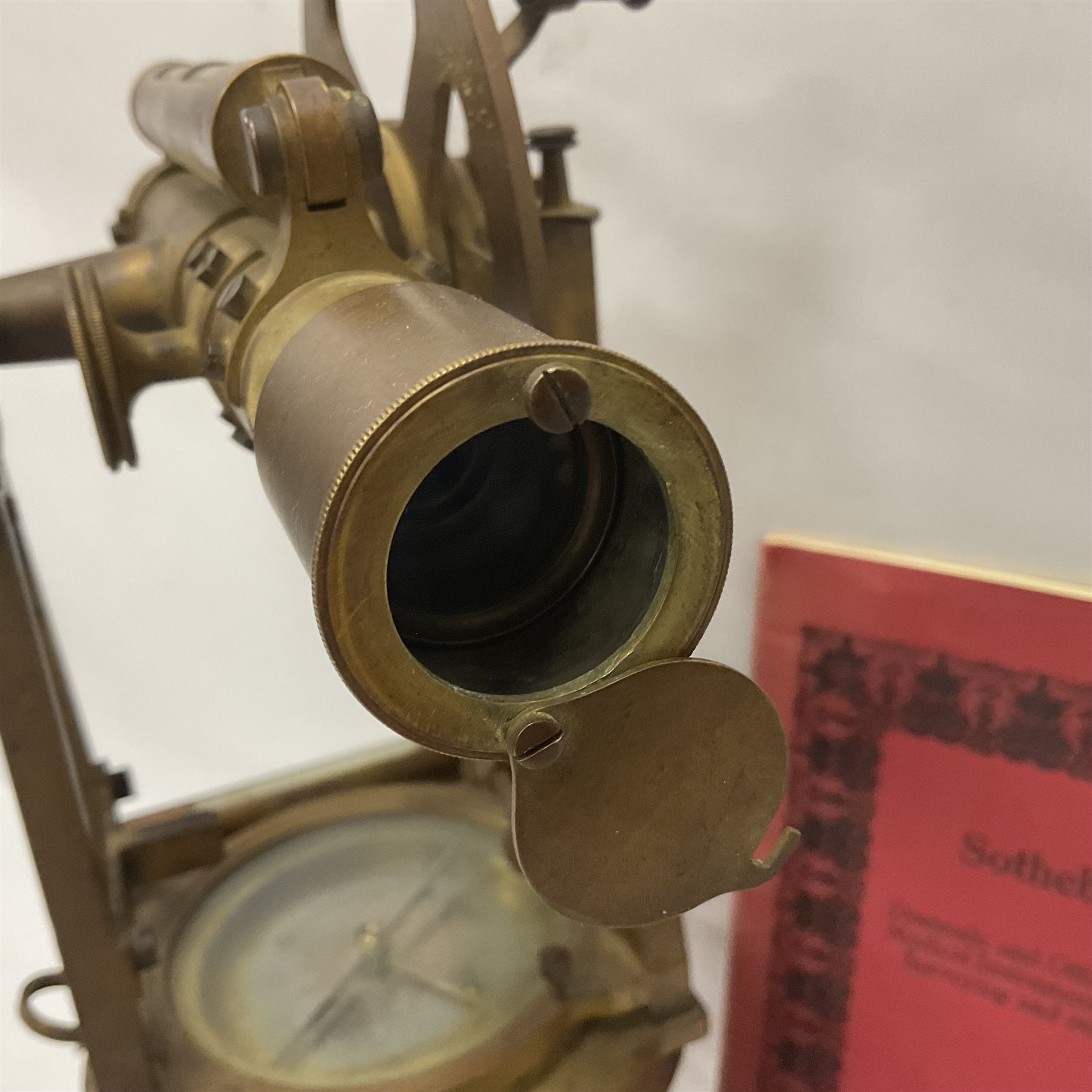 19th century brass transit theodolite by Troughton & Simms, the sighting telescope with rack and pinion focusing, above an inset compass, upon four levelling feet and a rectangular wooden base, including base H35.5cm