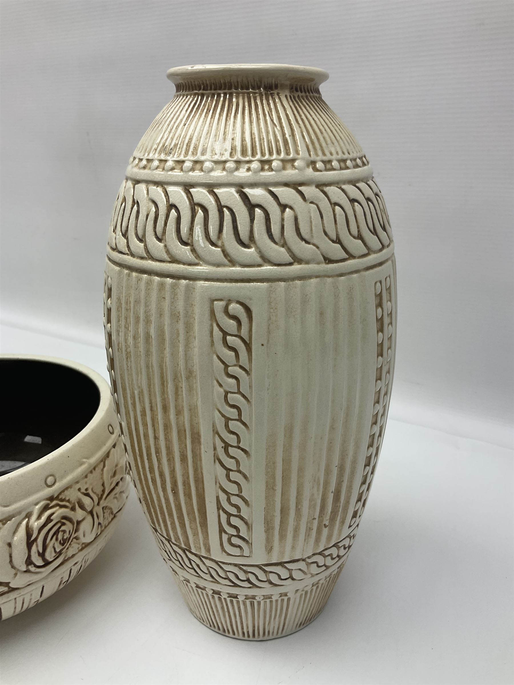 Bretby vase, of baluster form, with fluted and chain link decoration upon an ivory ground, together with a similar Bretby bowl, decorated with a band of roses upon an ivory ground, both with impressed marks beneath, and one other vase, with relief floral decoration and pewter cased rim, tallest H33cm