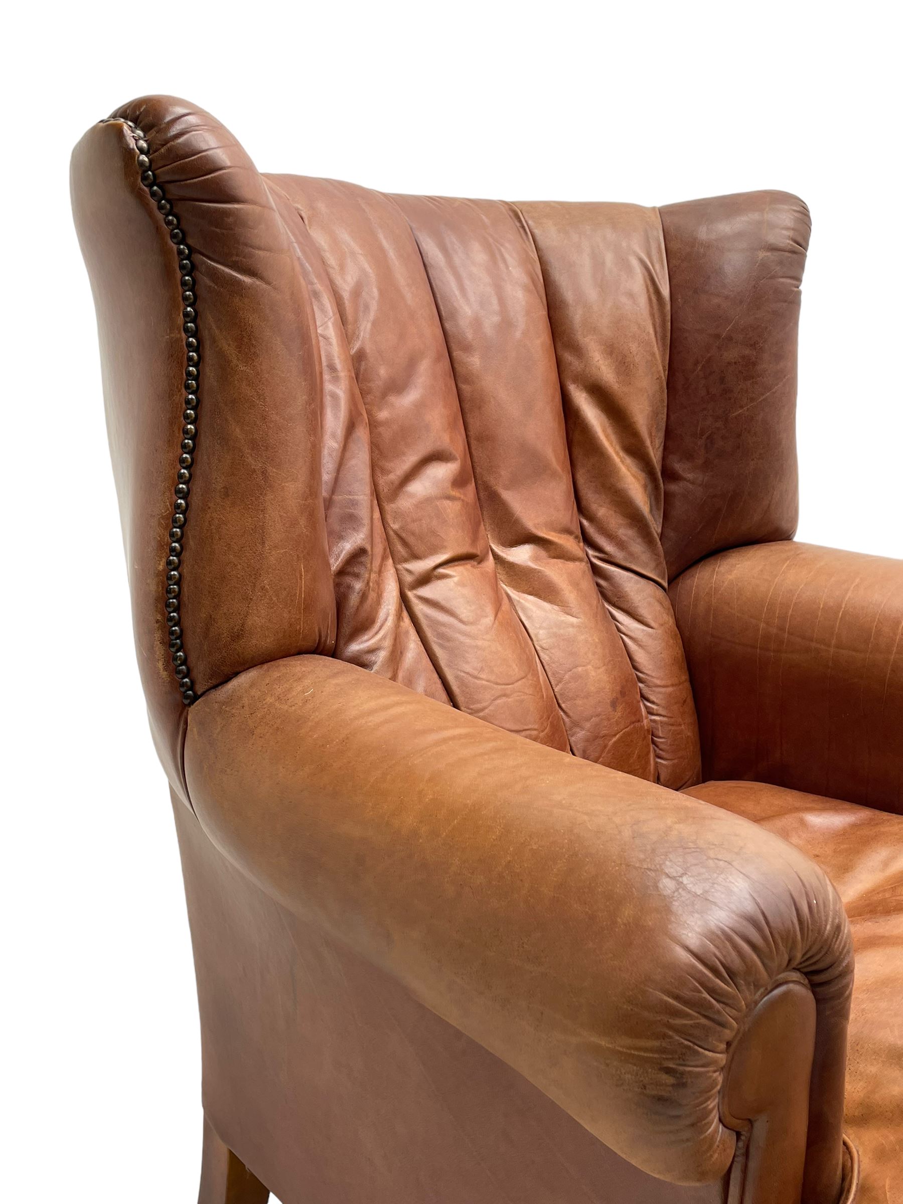 Tetrad - 'Blake' club armchair, fanned wingback and rolled arms upholstered in tan brown leather, on ball and claw carved cabriole feet 