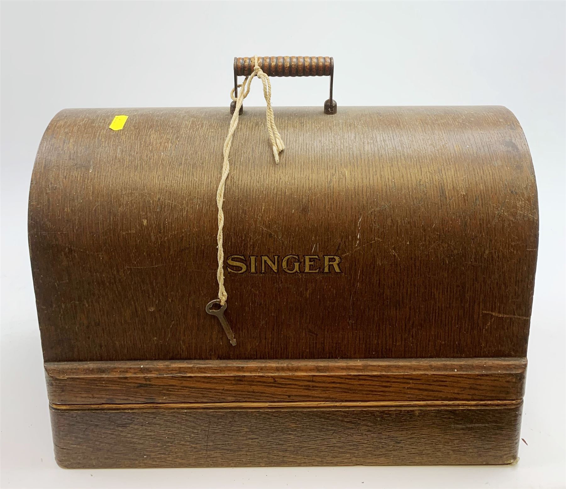 A cased vintage Singer hand crank sewing machine. 