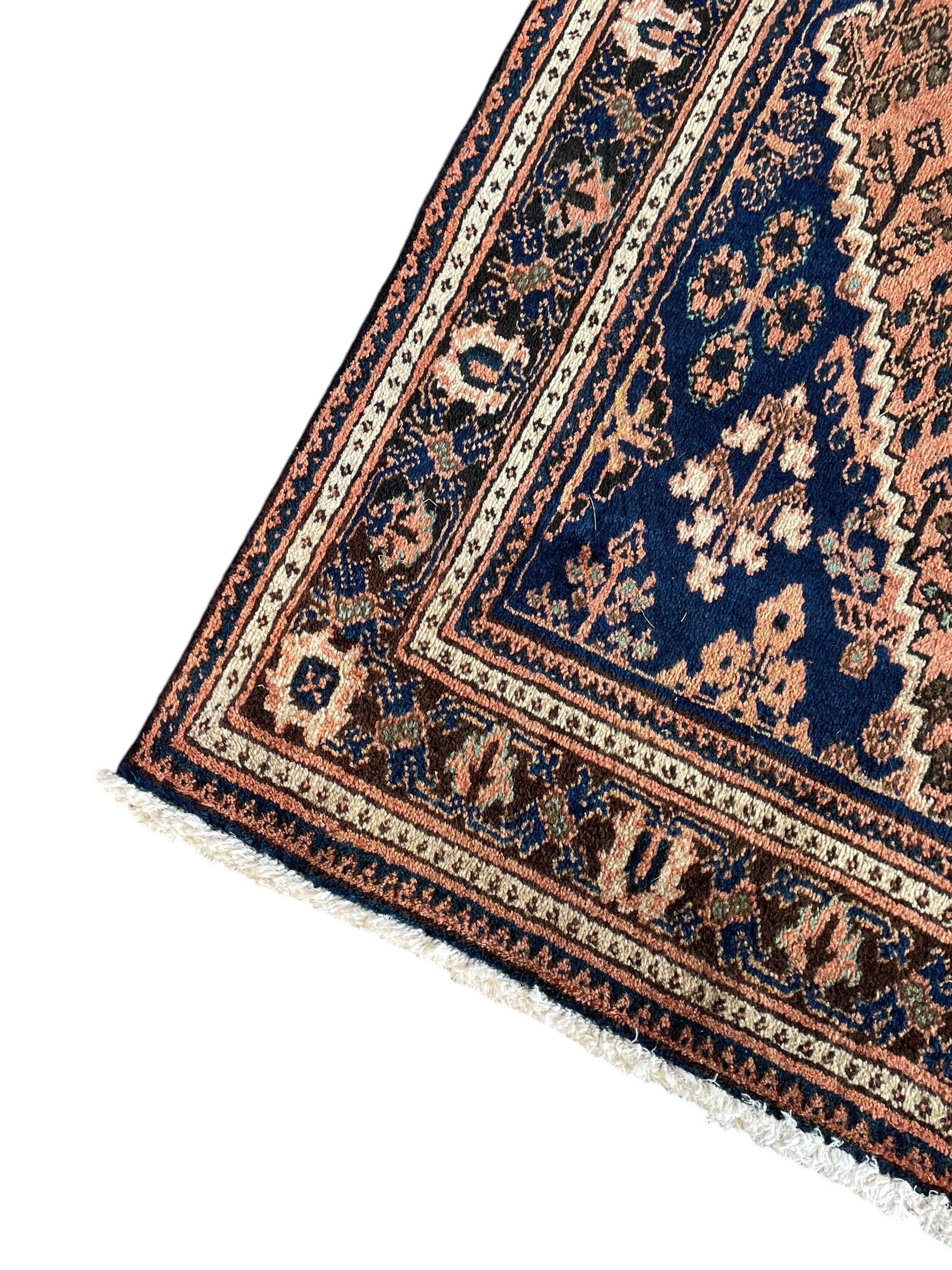 Persian Joshaghan peach and blue ground rug, central stepped lozenge medallion surrounded by bunches of floral motifs, repeating border decorated with stylised plant motifs, within multiple guard stripes