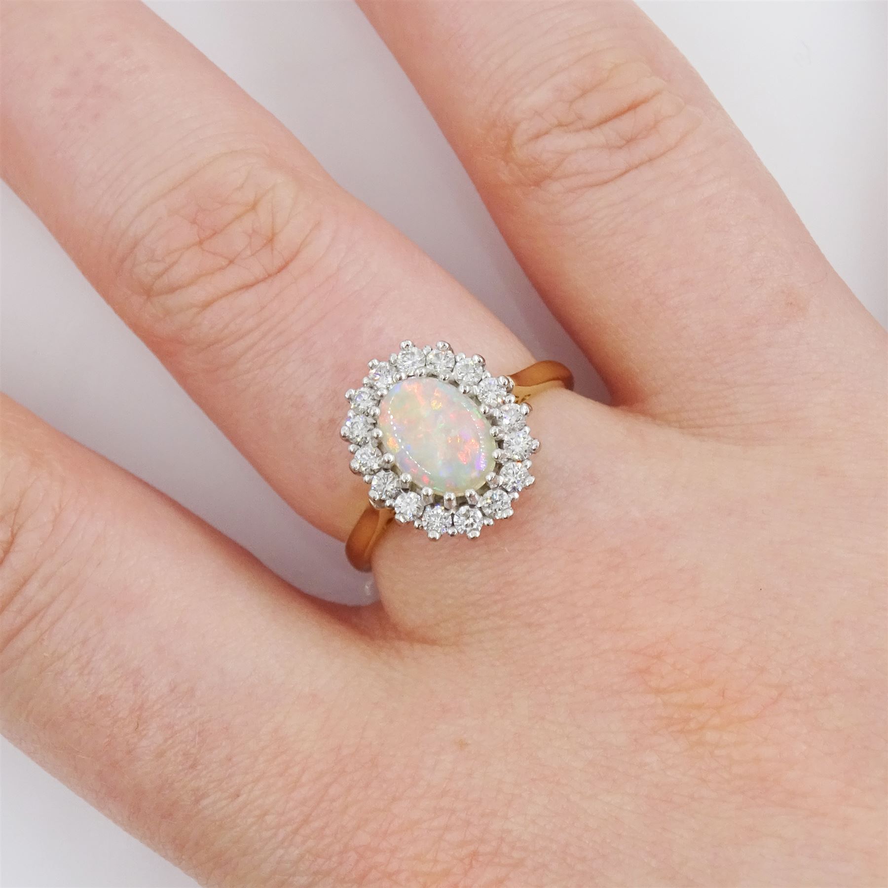 18ct gold opal and round brilliant cut diamond cluster ring, hallmarked, opal 0.66 carat, total diamond weight 0.36 carat