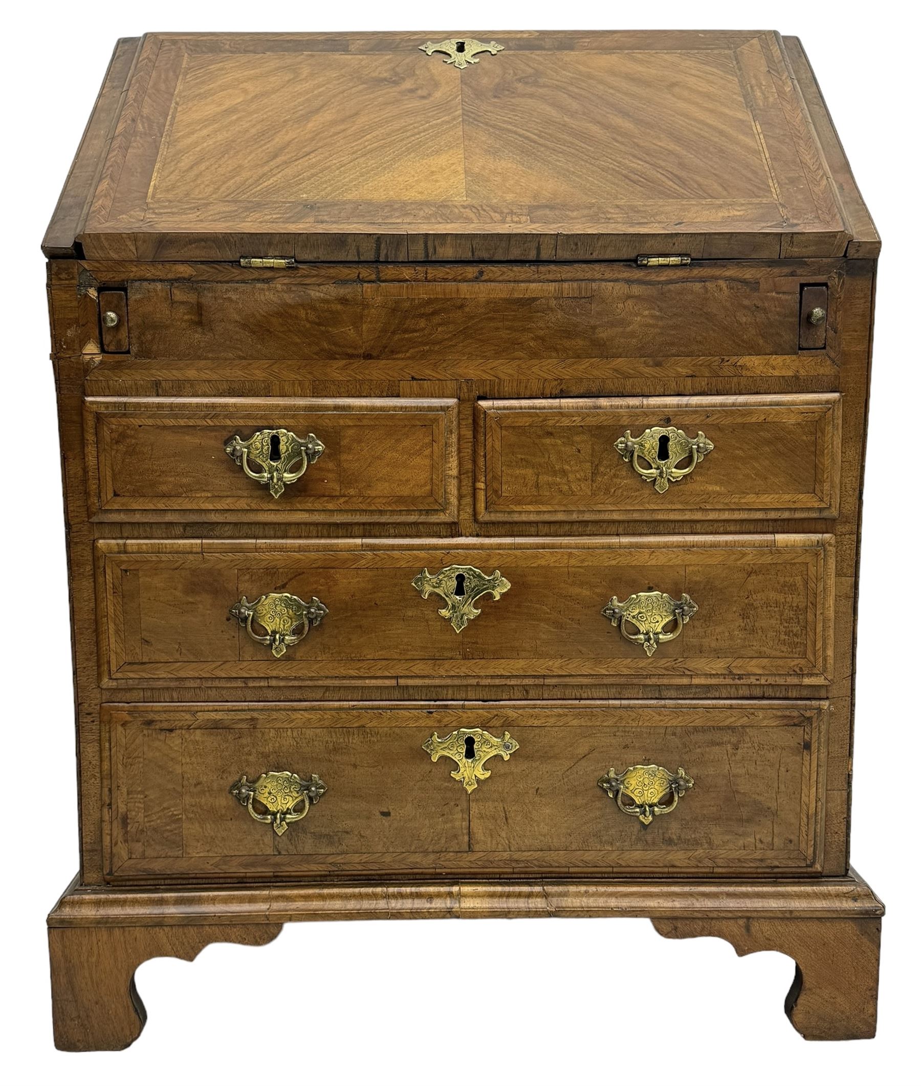 18th century walnut bureau, fall-front enclosing fitted interior with drawers and pigeonholes, over two short and two long drawers with brass escutcheon plates and handles, raised on bracket feet