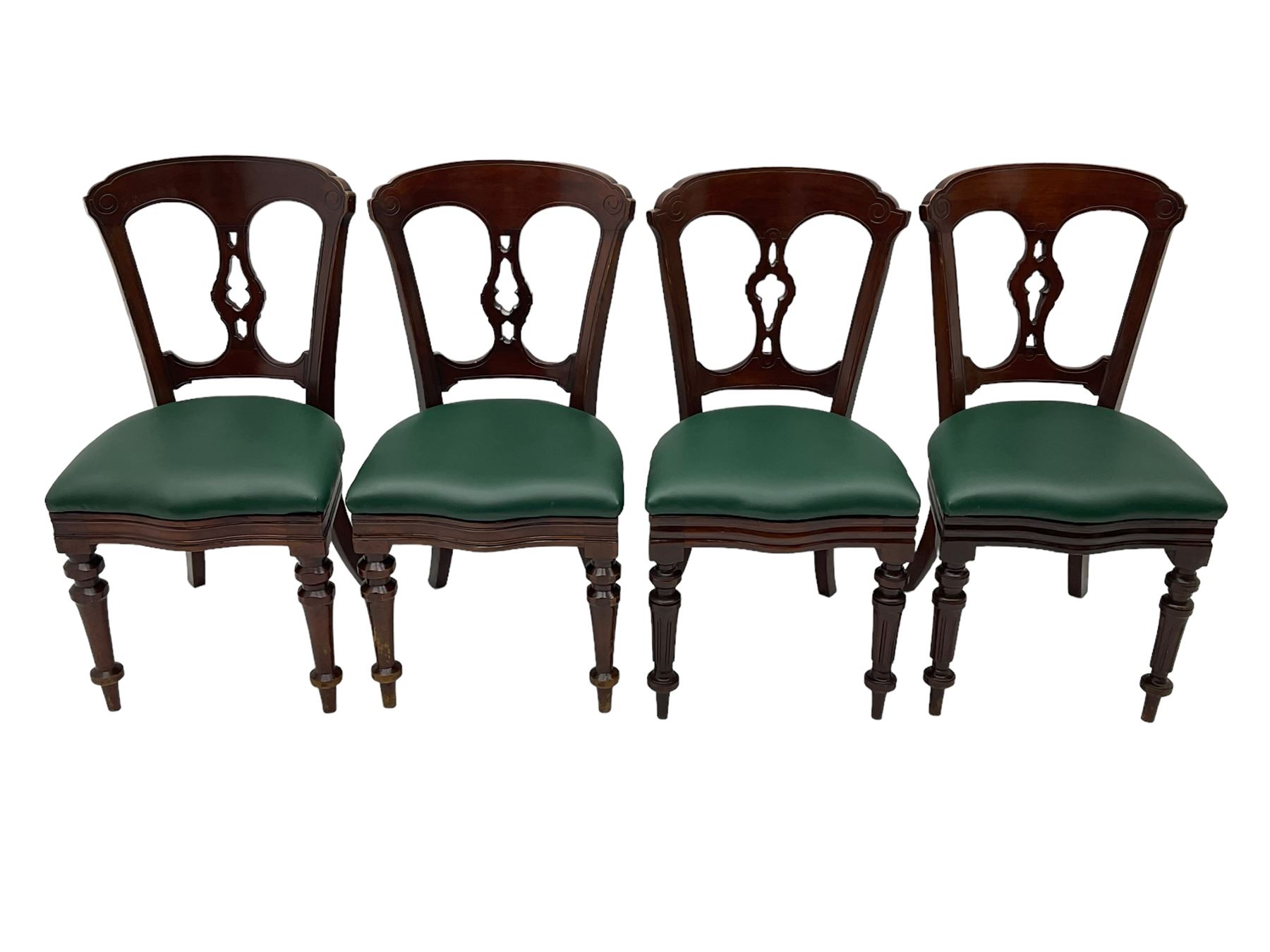 Matched set of twelve Victorian mahogany dining or boardroom chairs, the shaped cresting rail decorated with scrolled decoration, upholstered drop-on seats upholstered in green fabric, on turned supports  