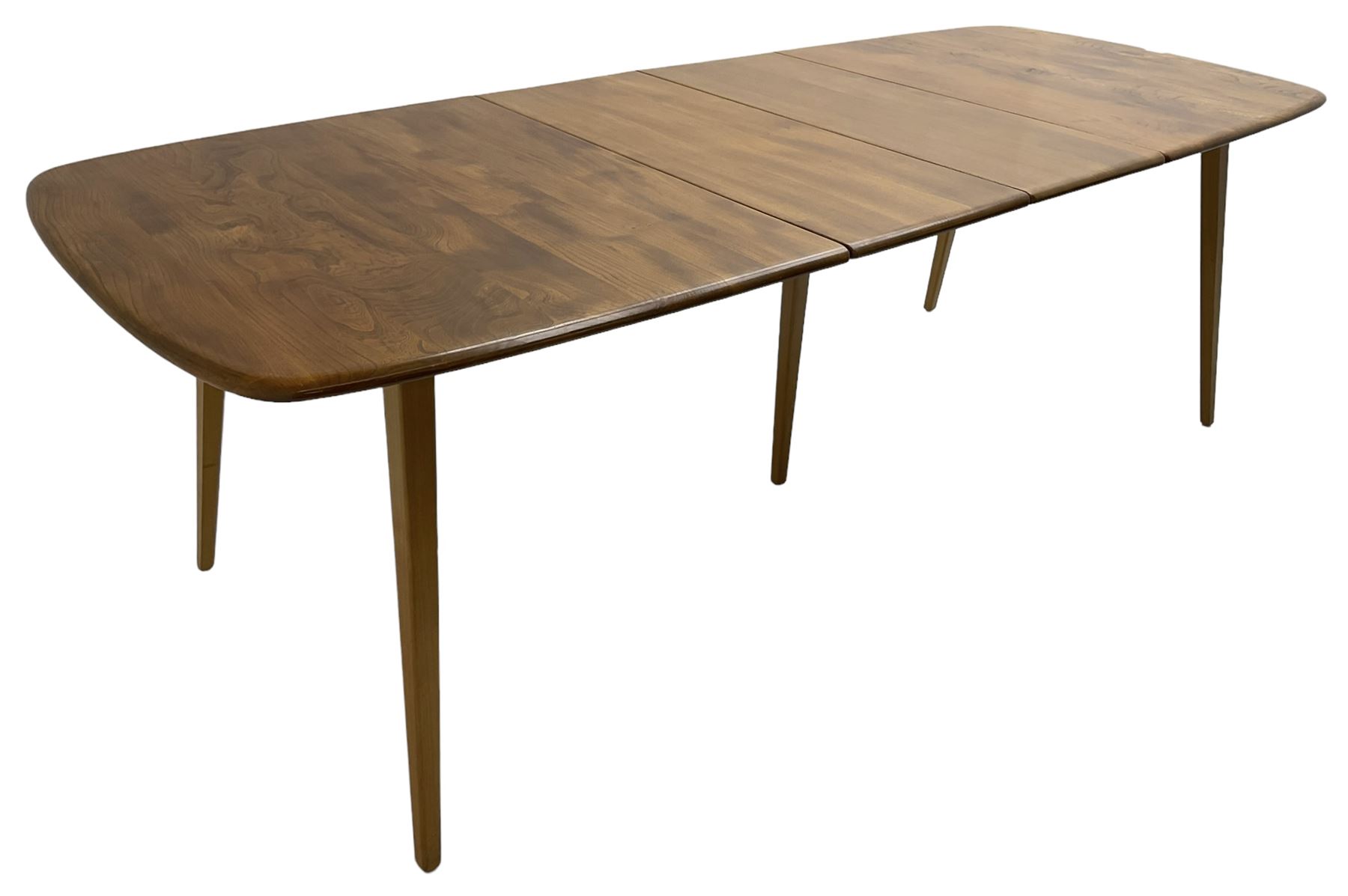 Ercol - light elm and beech 'Slide Leg Expanding Dining Table (444)', rectangular top with rounded corners, raised on tapered splayed supports, with two additional leaves