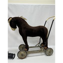 1920s/30s Panurge Pets push-a-long horse, with brown mohair body and white face, horse hair mane and tail and leather hooves, mounted upon a metal with rubber and metal wheels, including handle H71cm