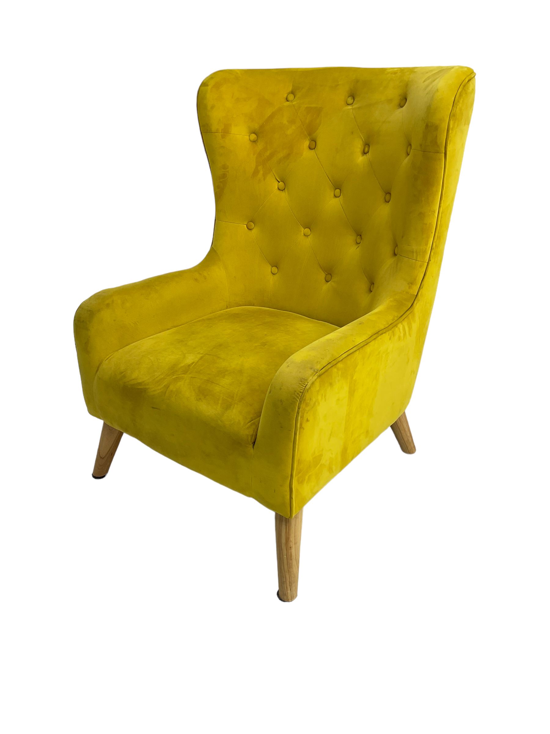 Mid-20th century design armchair, barrel back upholstered in buttoned mustard fabric, on tapering splayed front feet