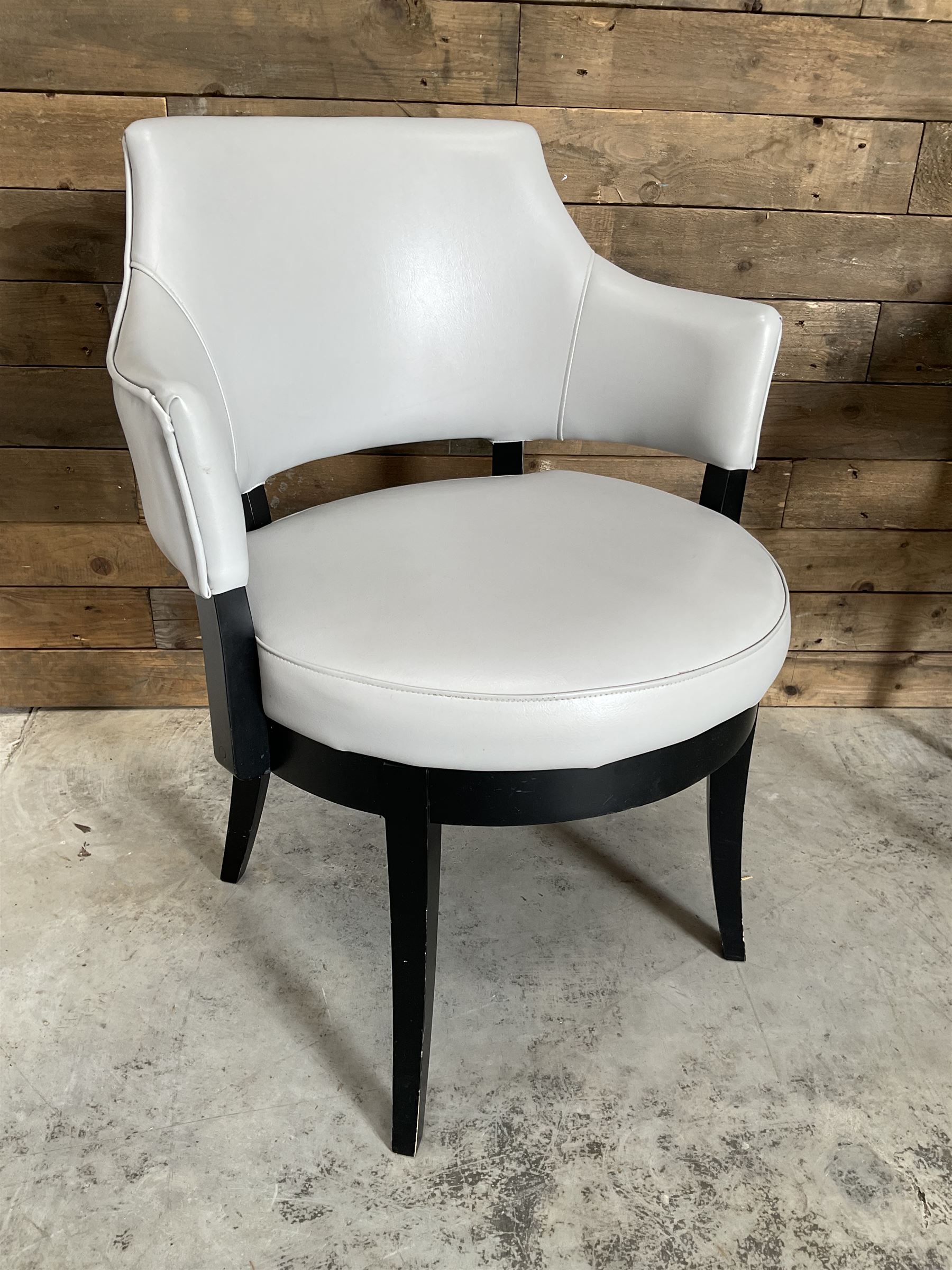 Four ebonised framed tub shaped armchairs, upholstered in grey fabric