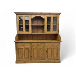 Large pine dresser, raised display cabinets over three drawers and three panelled cupboard...